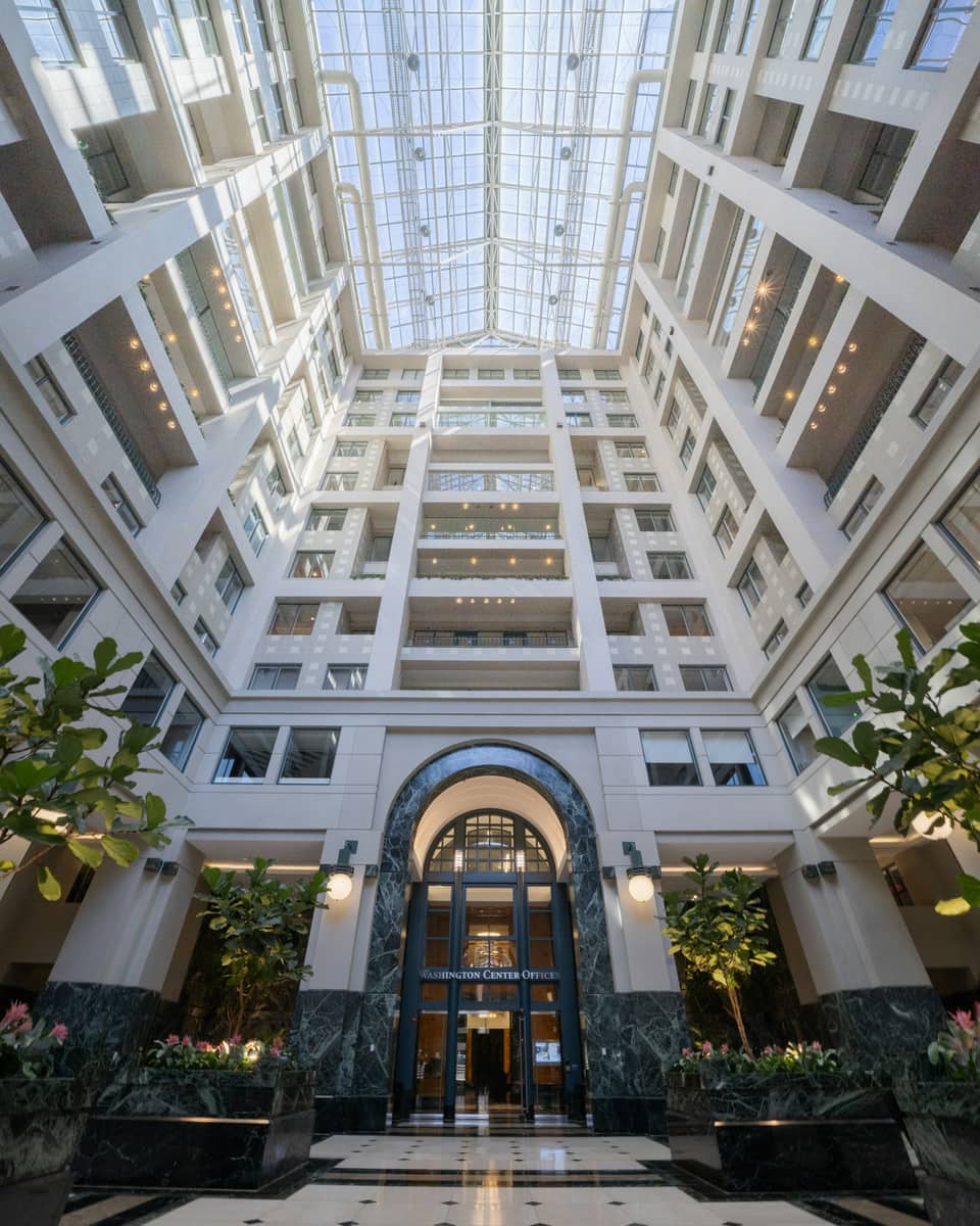 Historic building atrium with a glass skylight and tiered balconies